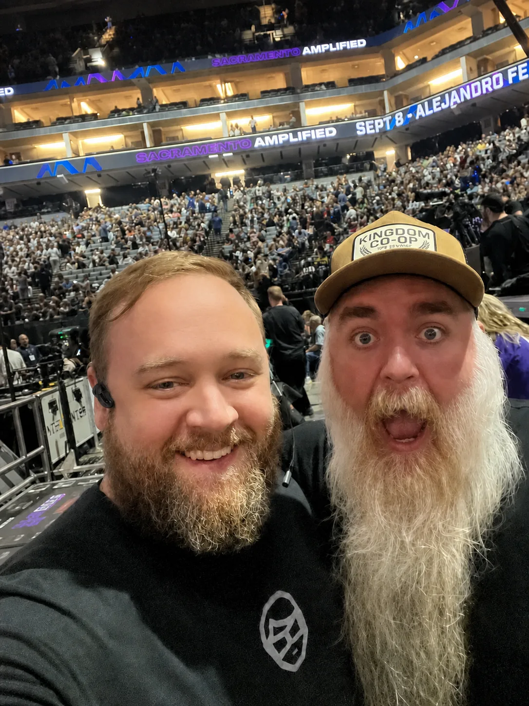 Crew at front of house with a full arena crowd behind