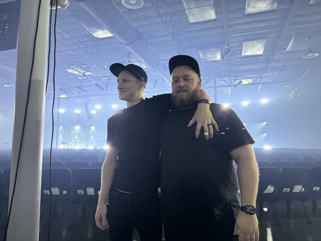 Two crew members in an arena before doors
